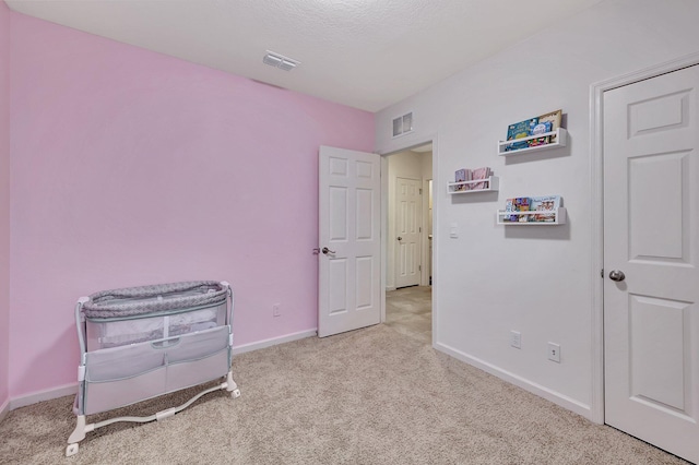 carpeted bedroom featuring a textured ceiling