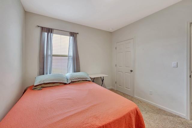 bedroom featuring light carpet