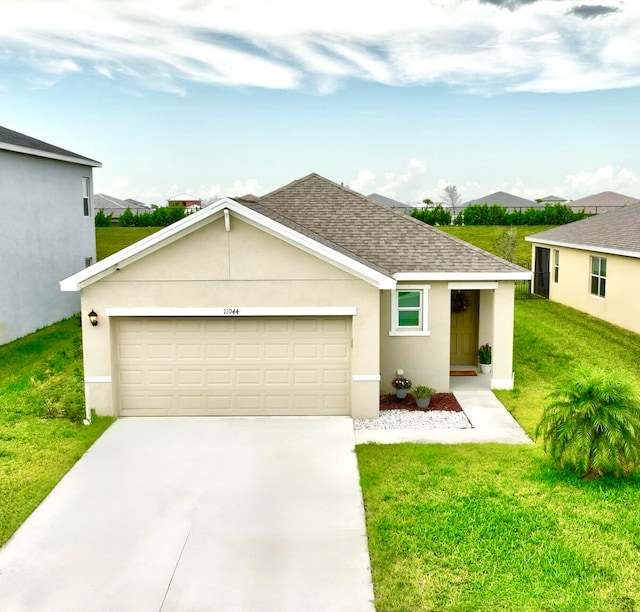 view of front of home with a front lawn and a garage