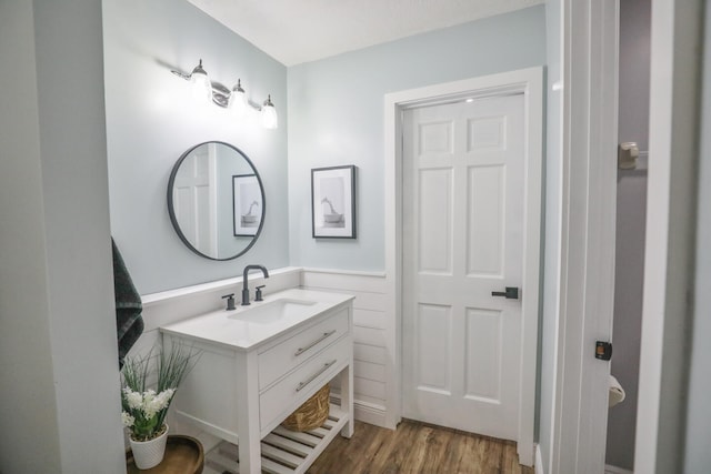 bathroom with hardwood / wood-style flooring and vanity