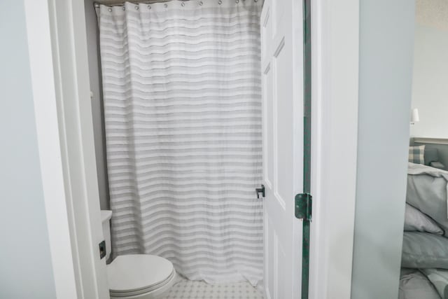 bathroom featuring tile patterned flooring and toilet