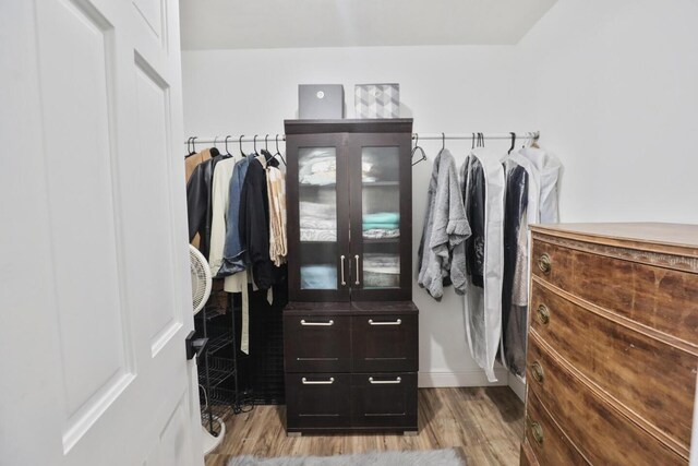 spacious closet featuring light hardwood / wood-style floors