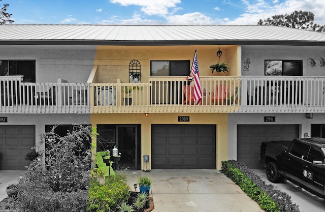 townhome / multi-family property with a balcony and a garage