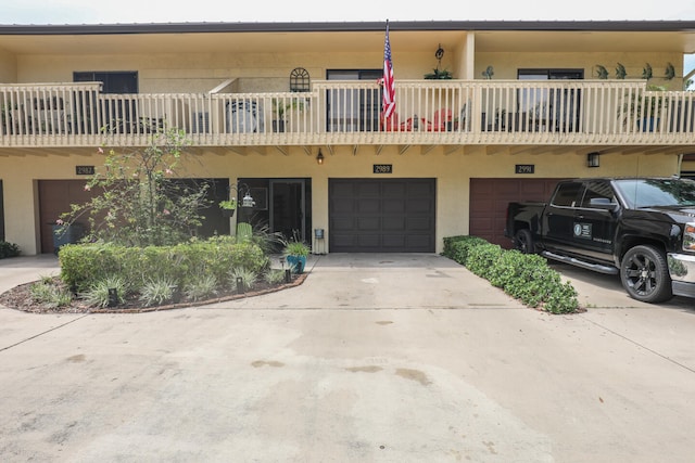 view of front facade featuring a balcony and a garage