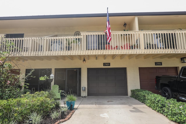 exterior space with a balcony and a garage