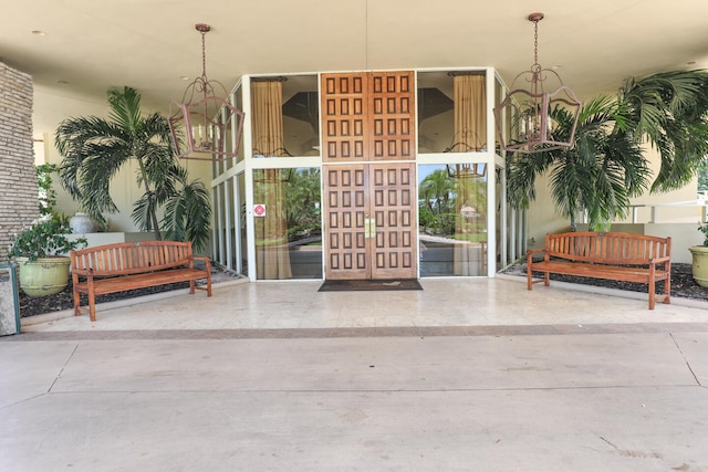 view of exterior entry with a patio area