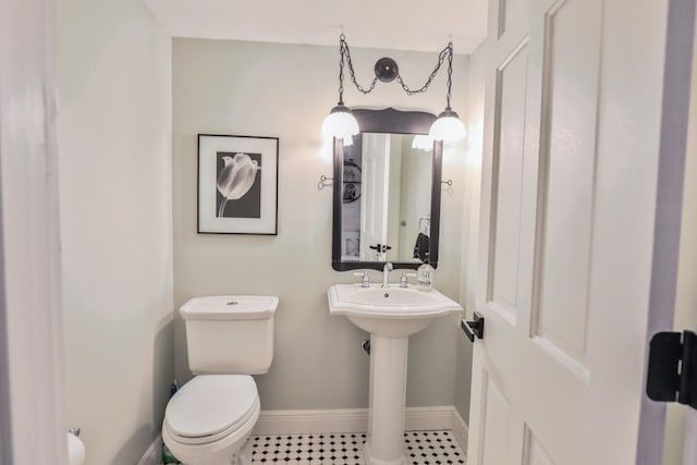 bathroom with toilet and tile patterned flooring