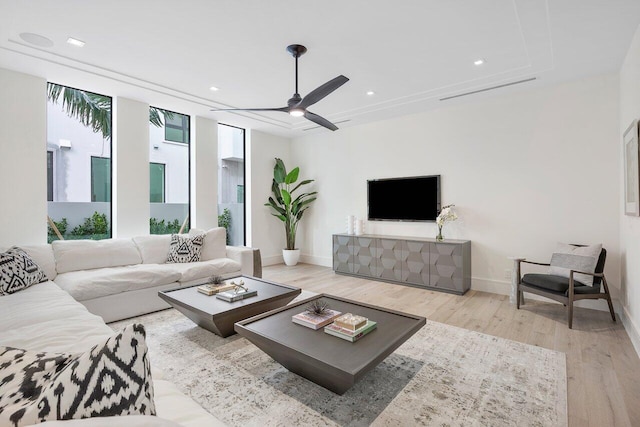 living room featuring light hardwood / wood-style floors and ceiling fan