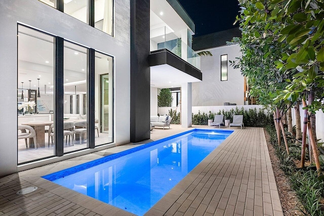 view of swimming pool with a patio