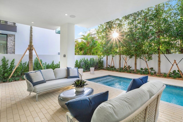 view of swimming pool with outdoor lounge area and a patio