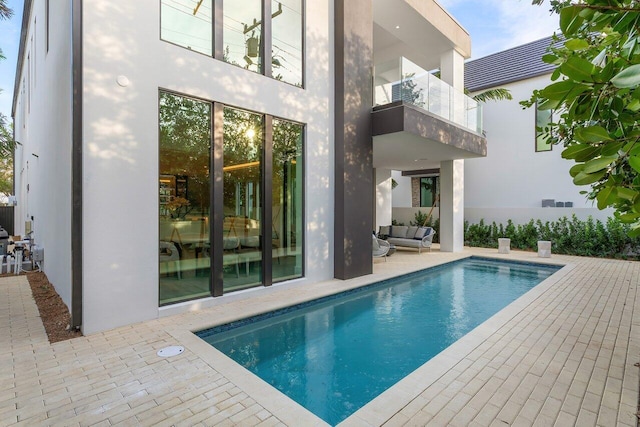 view of pool featuring an outdoor hangout area and a patio