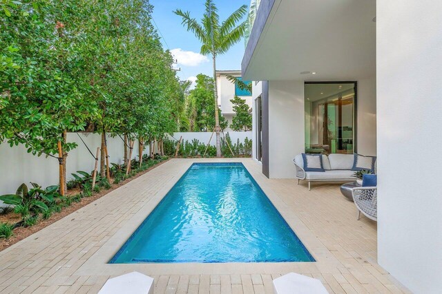 view of swimming pool with a patio