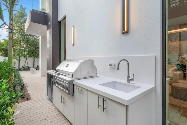 view of patio / terrace with sink, a grill, and exterior kitchen