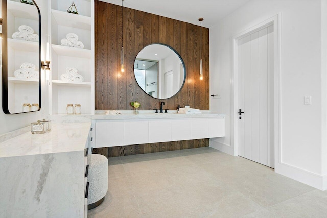 bathroom featuring wood walls, tile patterned flooring, and double vanity