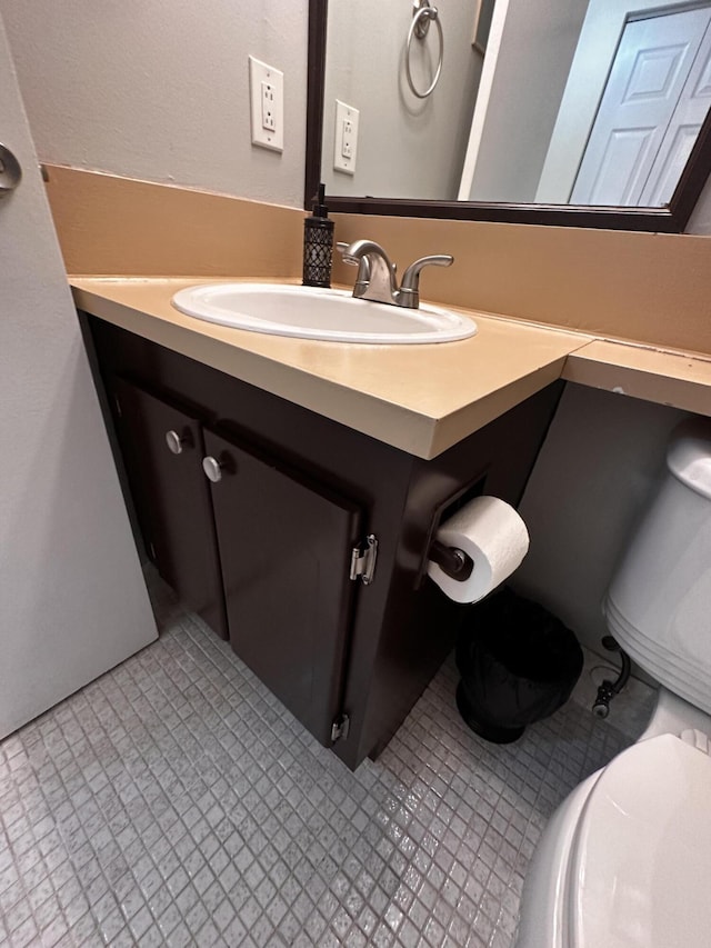 bathroom with tile patterned floors, vanity, and toilet