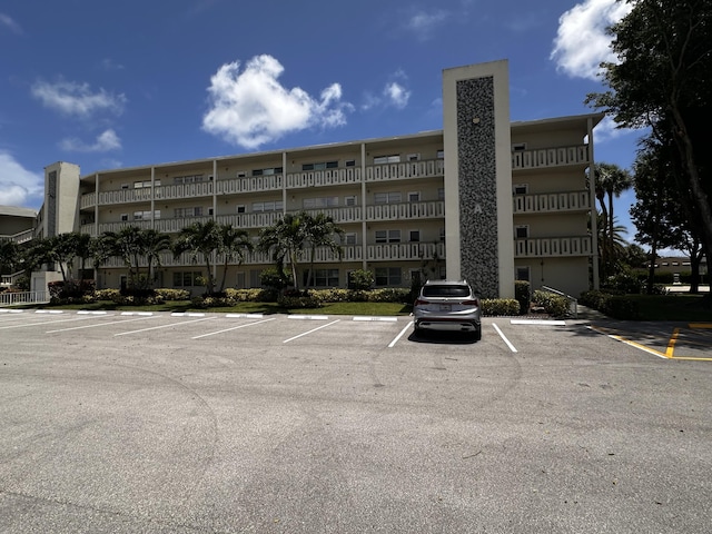 view of building exterior featuring uncovered parking