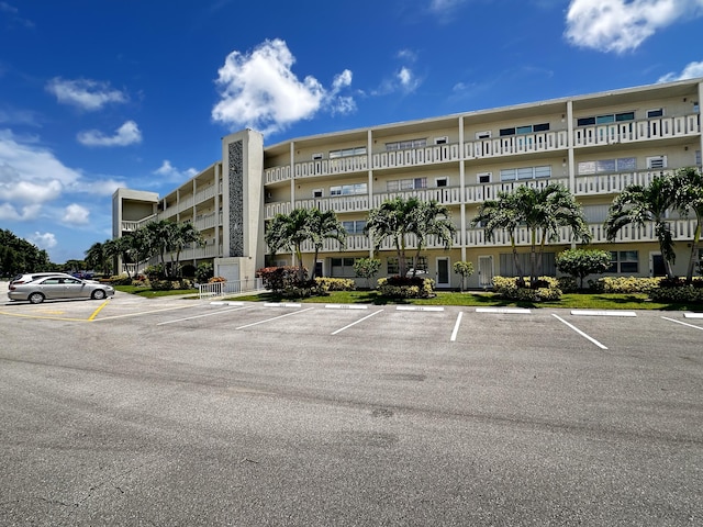 view of building exterior with uncovered parking