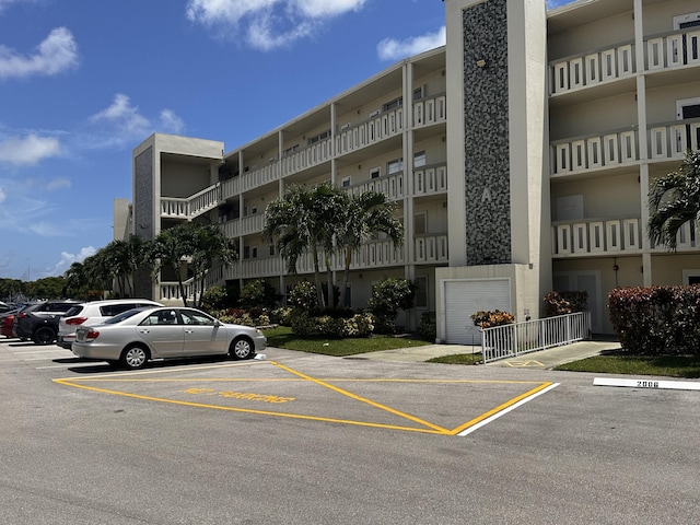 view of property featuring uncovered parking