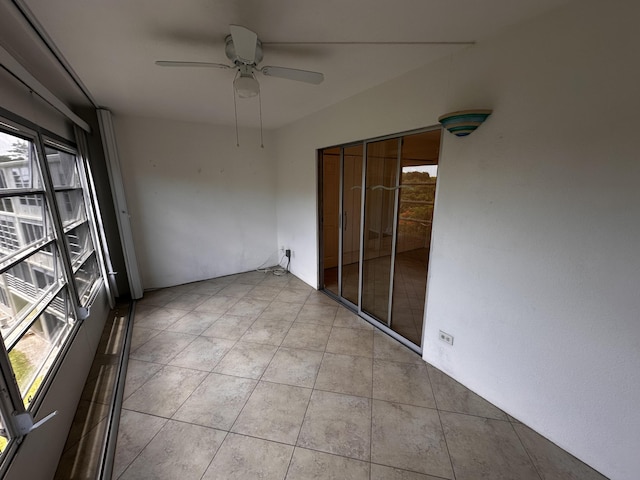 unfurnished sunroom with ceiling fan