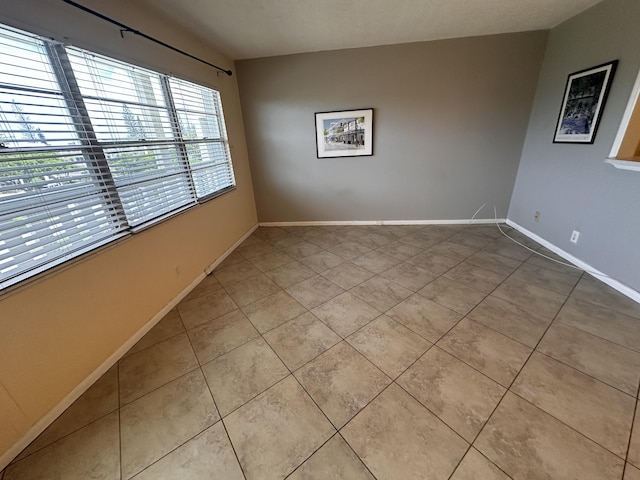 tiled spare room with baseboards