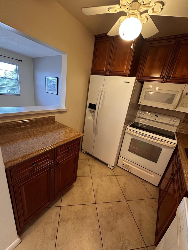 kitchen with white appliances, ceiling fan, and light tile patterned floors