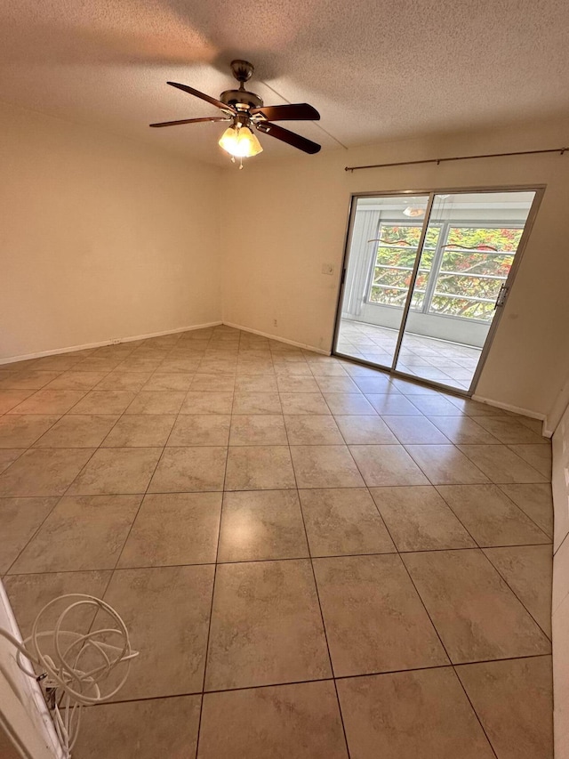 unfurnished room with light tile patterned floors, ceiling fan, a textured ceiling, and baseboards