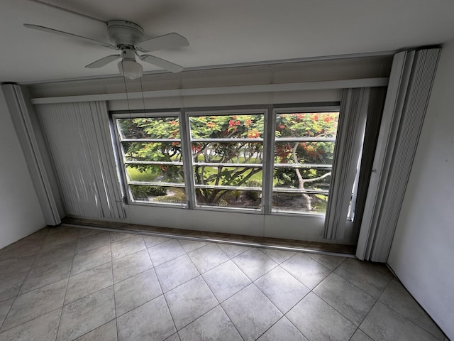 empty room with light tile patterned floors and ceiling fan