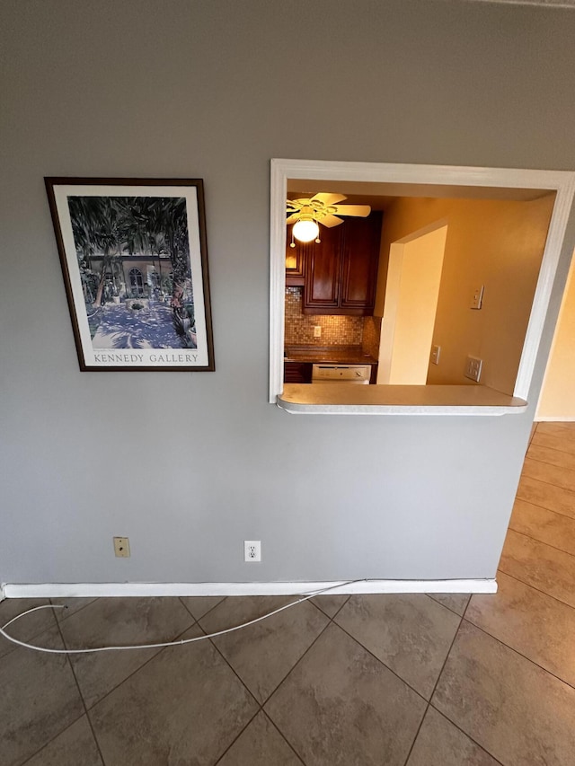 unfurnished dining area featuring ceiling fan and tile patterned flooring