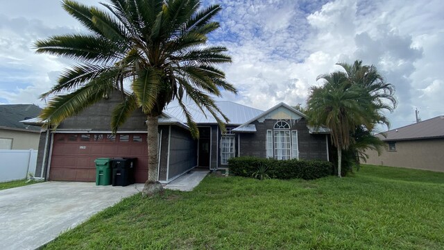 view of front of property with a garage and a front yard