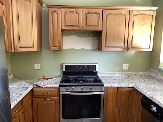 kitchen featuring stainless steel appliances and light stone counters