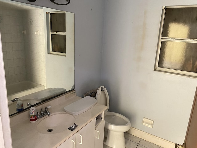 bathroom featuring tile patterned flooring, vanity, and toilet