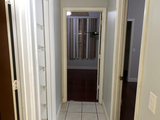 hall with light tile patterned floors