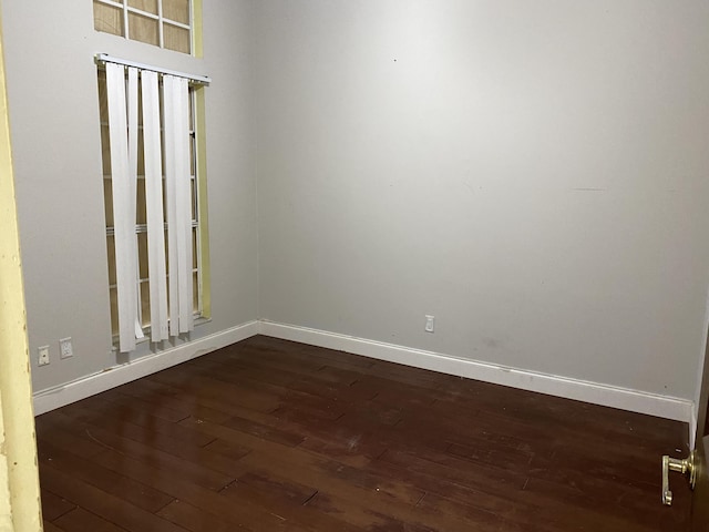 empty room featuring dark wood-type flooring