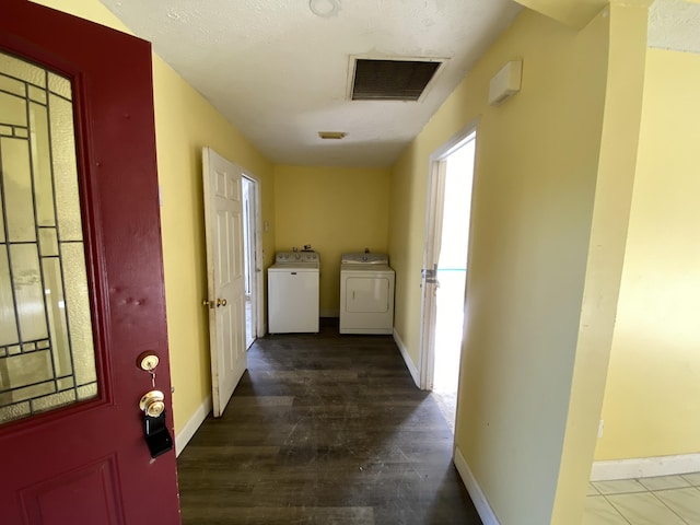 hall featuring washing machine and dryer, hardwood / wood-style floors, and a textured ceiling