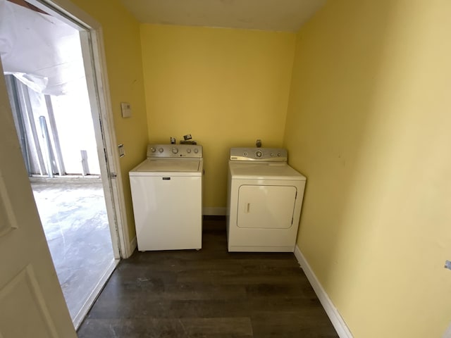 clothes washing area with washer and clothes dryer and dark hardwood / wood-style floors