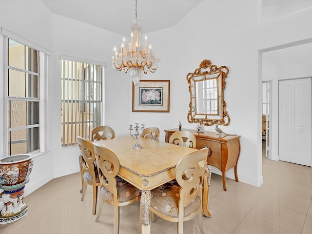 dining area featuring light tile patterned floors, high vaulted ceiling, and a chandelier