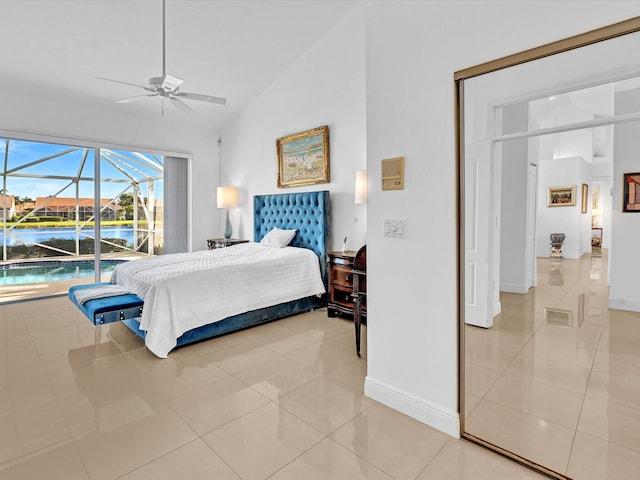 tiled bedroom with high vaulted ceiling, ceiling fan, and access to exterior