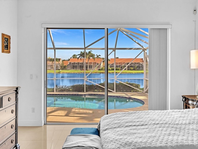 bedroom with a water view and light tile patterned floors