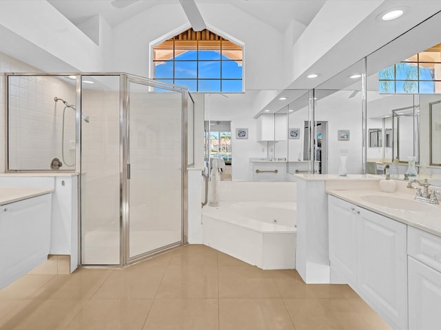 bathroom featuring vaulted ceiling, separate shower and tub, tile patterned flooring, and vanity