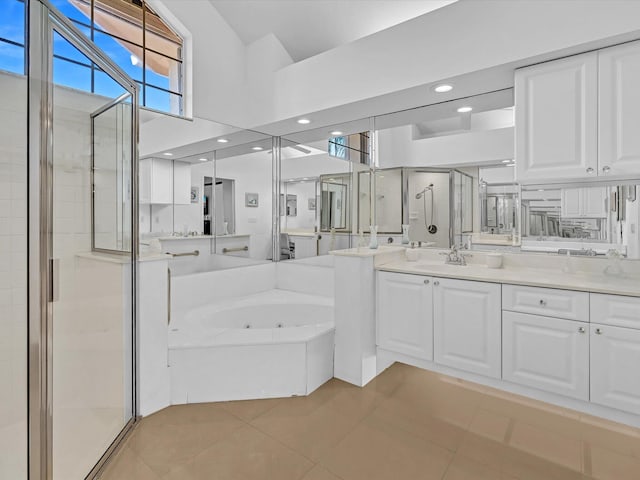 bathroom with tile patterned floors, plus walk in shower, vanity, and a towering ceiling