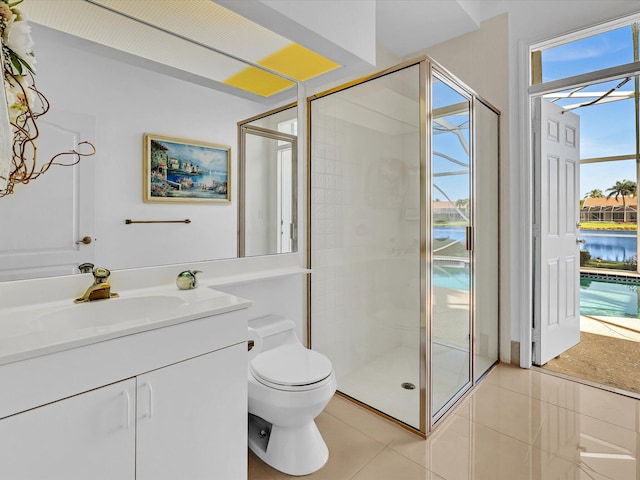 bathroom with a healthy amount of sunlight, an enclosed shower, tile patterned flooring, vanity, and toilet