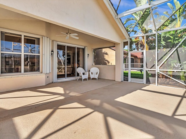 view of patio with ceiling fan and a lanai