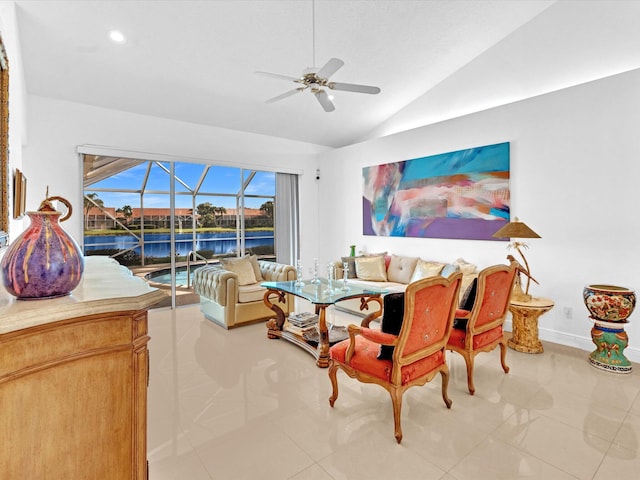 tiled dining room featuring ceiling fan, lofted ceiling, and a water view