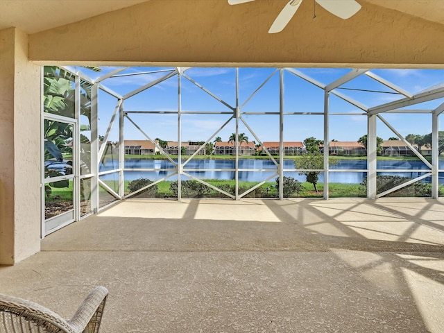 exterior space with ceiling fan, a lanai, and a water view