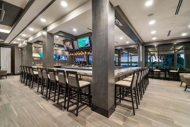 bar featuring light hardwood / wood-style floors