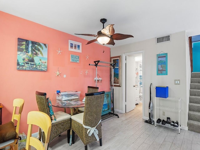 dining space with ceiling fan and light hardwood / wood-style floors