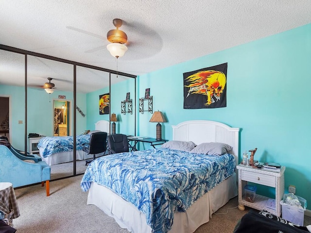 bedroom featuring ceiling fan, a closet, carpet, and a textured ceiling