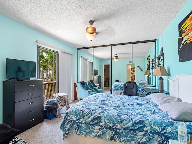 carpeted bedroom featuring ceiling fan, a textured ceiling, and a closet