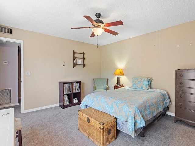 bedroom with carpet, ceiling fan, and a textured ceiling