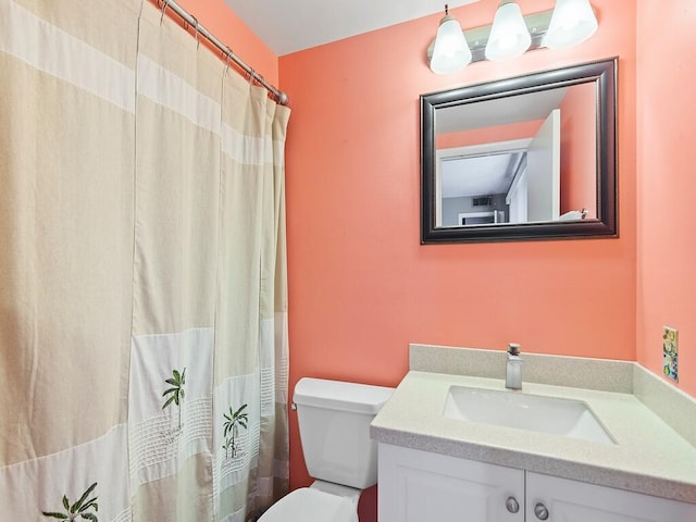 bathroom with vanity, toilet, and walk in shower